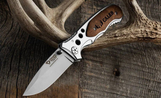 Palmetto black pocket knife lying on an antler