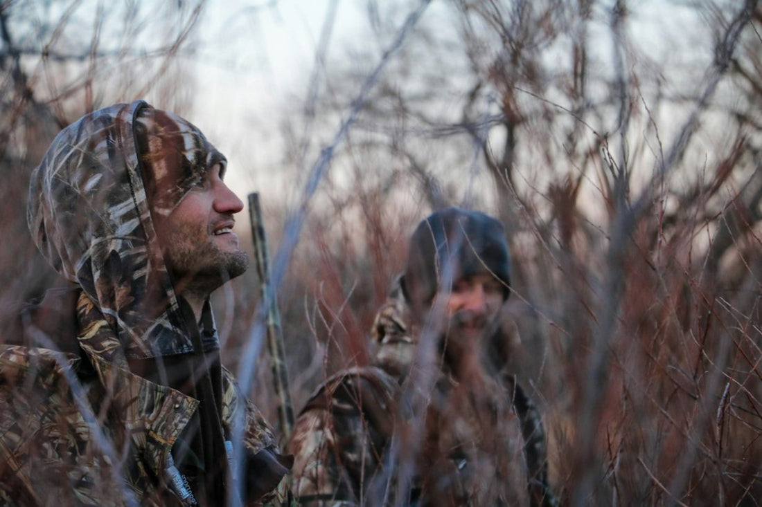 two men hunting in the woods