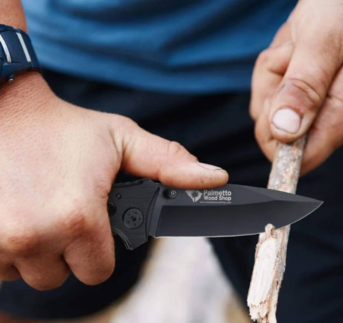 a man cutting a stick with a pocket knife