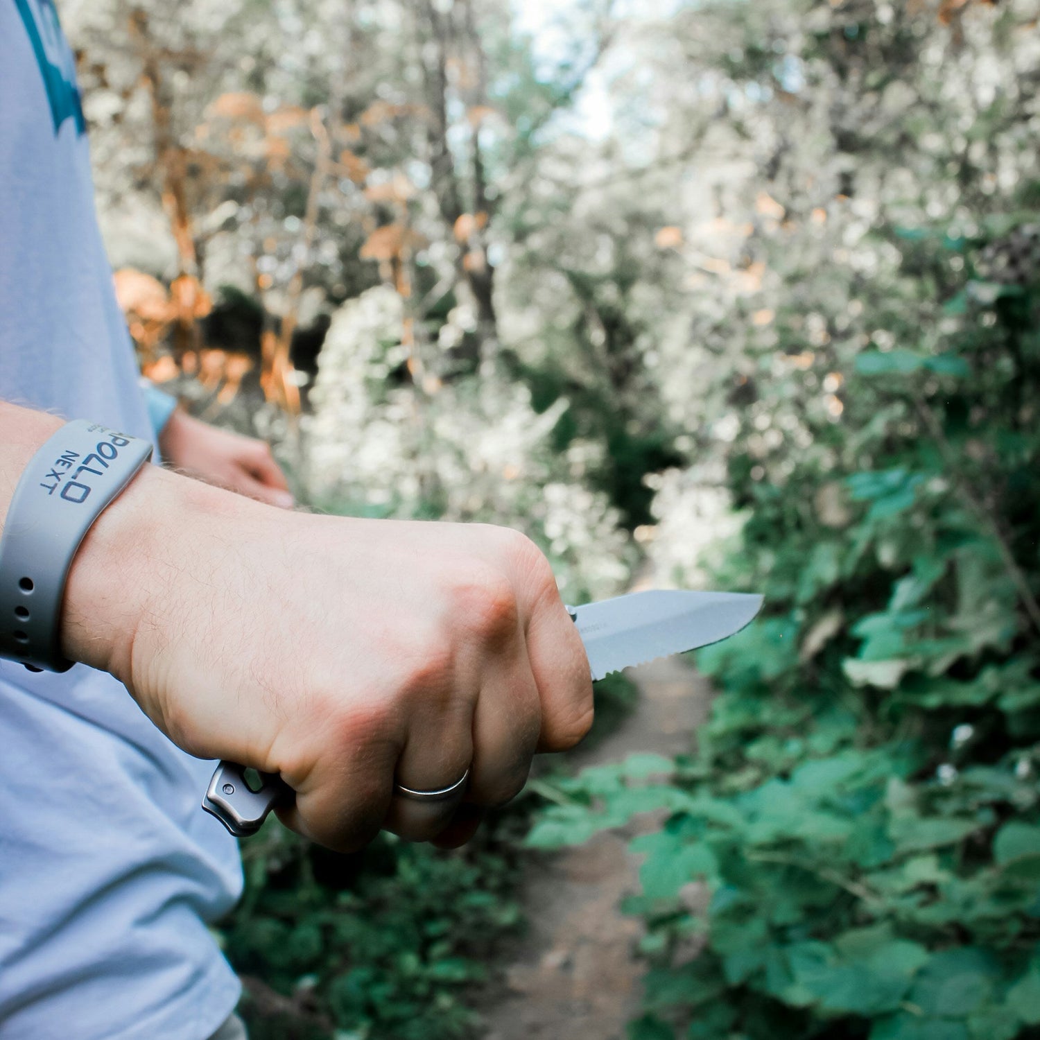 a man holding a knife outside