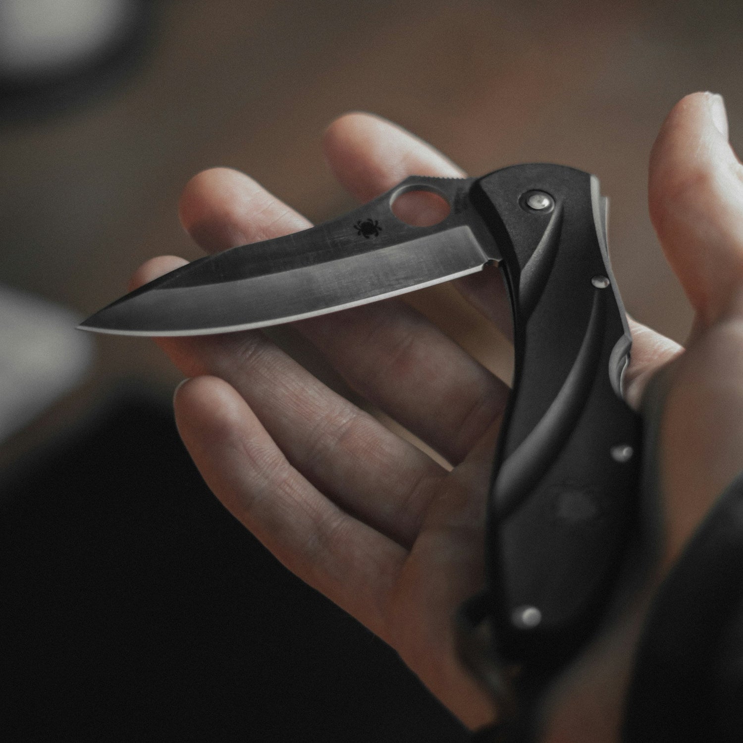 a person holding a pocket knife in palm of hand